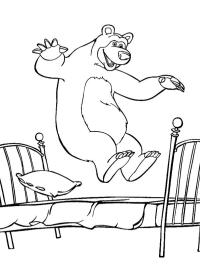 The bear jumps on the bed